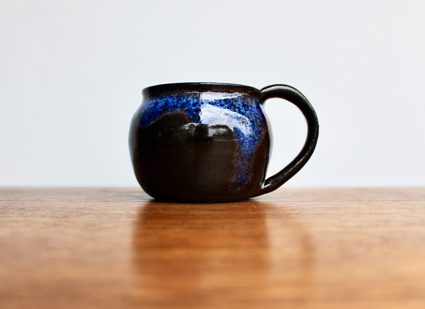 250ml Capacity Globe Mug, Dark Clay w/ Glassy Marbled Blue Glazed Rim-Drip Glaze, Dark Dark Stoneware Rounded Mug, Glossy Nearly Black Mug