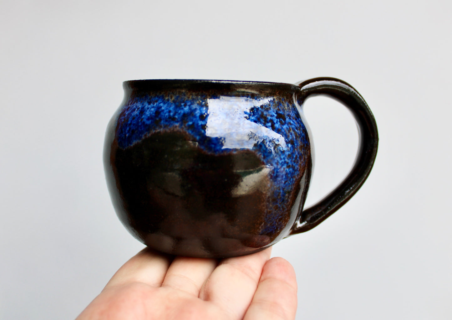250ml Capacity Globe Mug, Dark Clay w/ Glassy Marbled Blue Glazed Rim-Drip Glaze, Dark Dark Stoneware Rounded Mug, Glossy Nearly Black Mug